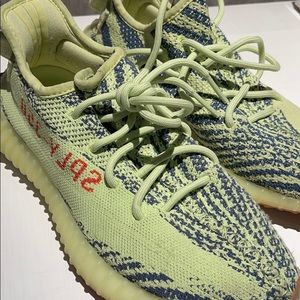 Neon yellow zebra yeezy’s with blue stripes